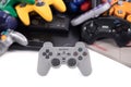 A PS1 Controller in front of Some Retro Video Game Controllers Royalty Free Stock Photo