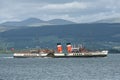 PS Waverly sailing off Esplanade, Greenock, Scotland against mountains on a cloudy day