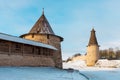 Pskov Kremlin towers separated by the frozen river mouth Pskova