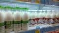 Milk in plastic bottles on supermarket shelves. Dairy shop. Sale, shopping, consumerism concept. Fresh food. Retail industry. Natu