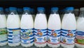 Milk in plastic bottles on supermarket shelves. Dairy shop. Sale, shopping, consumerism concept. Fresh food. Retail industry. Natu