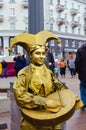 PSKOV, RUSSIA - March 10, 2019: living statue young woman painted in gold. Russian costume