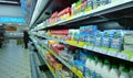 Rows of shelves with dairy products, cottage cheese bottles of milk, yogurt in a supermarket. Concept of problem rising food price