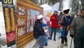 Traditional festival and trade fair in city park. Crowd of people walking. Shopping tents on the street. Cold weather. Real life i Royalty Free Stock Photo