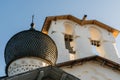 Pskov, Russia, September 6, 2023. Black dome of the church and bells at sunset.