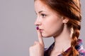 Psst - a beautiful girl with pigtails making a shushing gesture Royalty Free Stock Photo