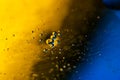 Psychedelic blueand yellow oil and water abstract background. Abstract colorful background. Foam of Soap with Bubbles macro shot.