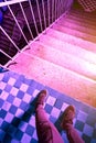 Psychedelic photo of legs in sneakers near the stairs down. Fear of going forward. A long hard way. Conceptual Royalty Free Stock Photo