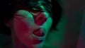 Psychedelic portrait of woman in bath with water, closeup of face, craziness