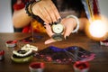 Psychic readings and clairvoyance concept - Crystal ball fortune teller with hands hold retro pocket watch and Tarot cards reading Royalty Free Stock Photo
