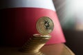 Psychical golden bitcoin stand in front of the Polish flag Royalty Free Stock Photo