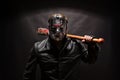 Psycho killer in hockey mask on black background.