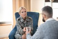 Psychoanalyst giving glass of water to military woman
