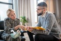 Psychoanalyst holding medical record of military woman