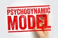 PSYCHODYNAMIC MODEL shown as bold red stamp text with a hand writing the phrase, referencing psychology frameworks, unconscious Royalty Free Stock Photo