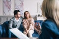 Beautiful and happy young couple visiting psychologist for relationship counseling. Royalty Free Stock Photo