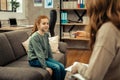 Cute positive girl looking at her therapist Royalty Free Stock Photo