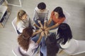 Women sitting in circle and holding hands in therapy session or support group meeting Royalty Free Stock Photo