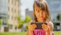Psychological image of cute little girl addicted to likes: Social networks feeds her neediness. Close up portrait of sad child Royalty Free Stock Photo