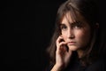 Psychological portrait of a beautiful young girl on a black background