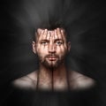 psychological portrait of a person, double exposure, face shines through hands, surreal portrait of a man covering his face and Royalty Free Stock Photo