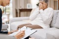 Psychologist, consulting or old woman crying in counseling with therapist writing notes in conversation. Stressed Royalty Free Stock Photo