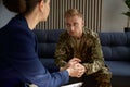 Psychologist holding hand of war veteran or soldier talking about his trauma Royalty Free Stock Photo