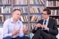 Psychologist listening his male patient at office Royalty Free Stock Photo
