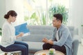 Psychologist listening to her patient and writing down notes, mental health and counseling concept Royalty Free Stock Photo