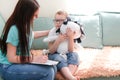 Psychologist listens to a small child during a therapy session Royalty Free Stock Photo