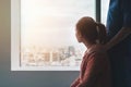 Psychologist sitting and touch young depressed asian woman for encouragement near window with low light environment, PTSD Mental