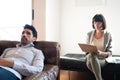 Psychologist taking notes during therapy session. Royalty Free Stock Photo