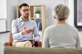 Psychologist talking to senior woman patient