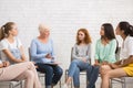 Psychologist Talking With Women During Support Group Meeting Sitting Indoor