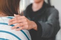 Psychologist touch young depressed asian woman for encouragement near window, Selective focus, PTSD Mental health concept Royalty Free Stock Photo