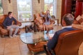 Psychologist. Young couple sitting on sofa, solve problem, doctor sitting in chair listening to them and taking notes