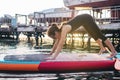 Close-up of a girl doing yoga on sub board. Psychology meditation, relaxation and self-healing concept. Lonely woman alone on