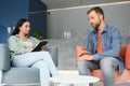 psychology, mental therapy and people concept - woman psychologist talking to sad young man patient at psychotherapy Royalty Free Stock Photo