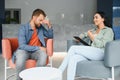 psychology, mental therapy and people concept - woman psychologist talking to sad young man patient at psychotherapy Royalty Free Stock Photo