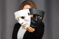 Psychology and psychiatry,mental health,mind and feelings,two facial masks black and white in the hands of a woman
