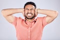 Psychosis, mental health and angry Asian man with bipolar isolated on a grey studio background. Stress, fear and scared