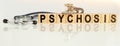 PSYCHOSIS the word on wooden cubes, cubes stand on a reflective white surface, on cubes - a stethoscope Royalty Free Stock Photo