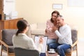 Psychotherapist and happy couple having meeting in office Royalty Free Stock Photo