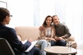 Psychotherapist and happy couple having meeting in office Royalty Free Stock Photo