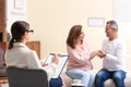 Psychotherapist and happy couple having meeting in office Royalty Free Stock Photo