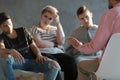 Psychotherapist supporting difficult teenagers during group therapy Royalty Free Stock Photo