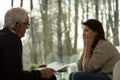 Psychotherapist talking with depressed woman