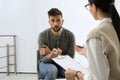 Psychotherapist working with drug addicted man indoors Royalty Free Stock Photo