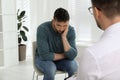 Psychotherapist working with drug addicted man indoors Royalty Free Stock Photo