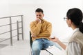 Psychotherapist working with drug addicted man indoors Royalty Free Stock Photo